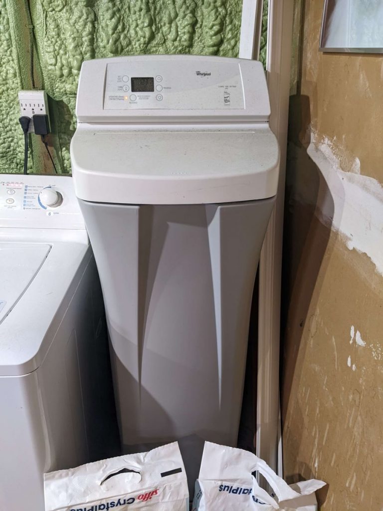 water softener in a room beside washing machine