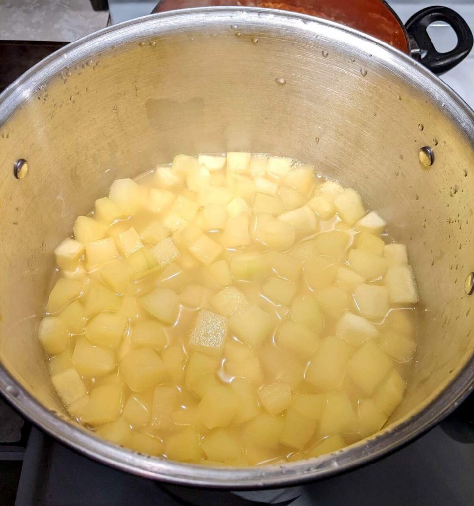 Zucchini cubes cooking in a pot with pineapple juice